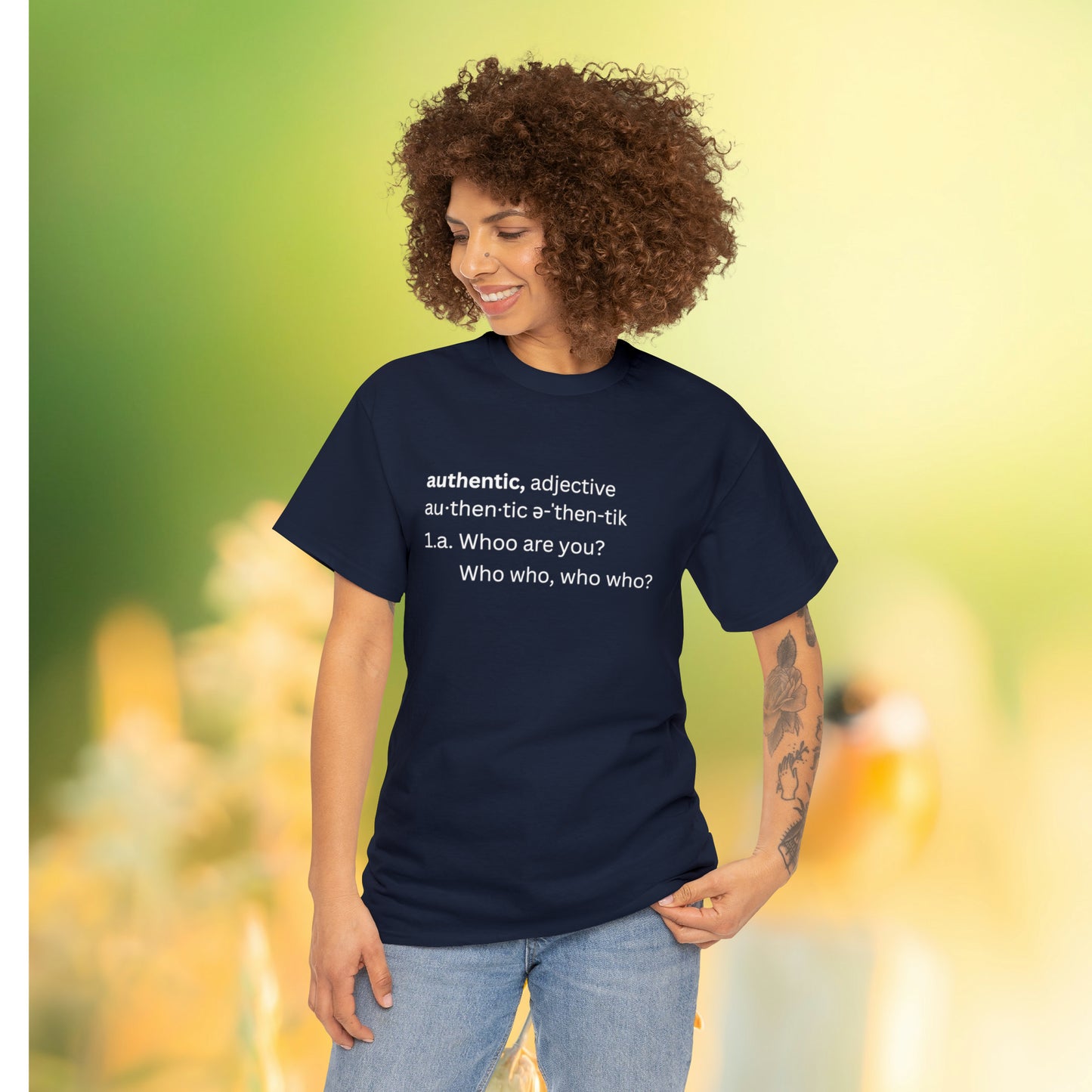 Curly haired women in field wearing black Tee reading "Authentic, adjective " Whoo are you?