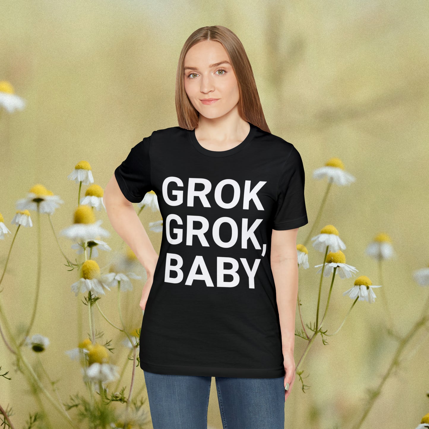 Young women standing in a field wearing a black tee with "Grok Grok, Baby!"