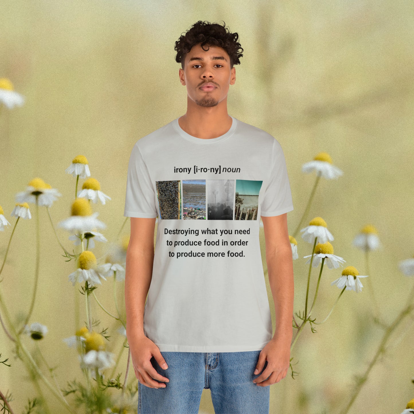 Young man wearing silver tee with graphic "Irony" with a daisy background