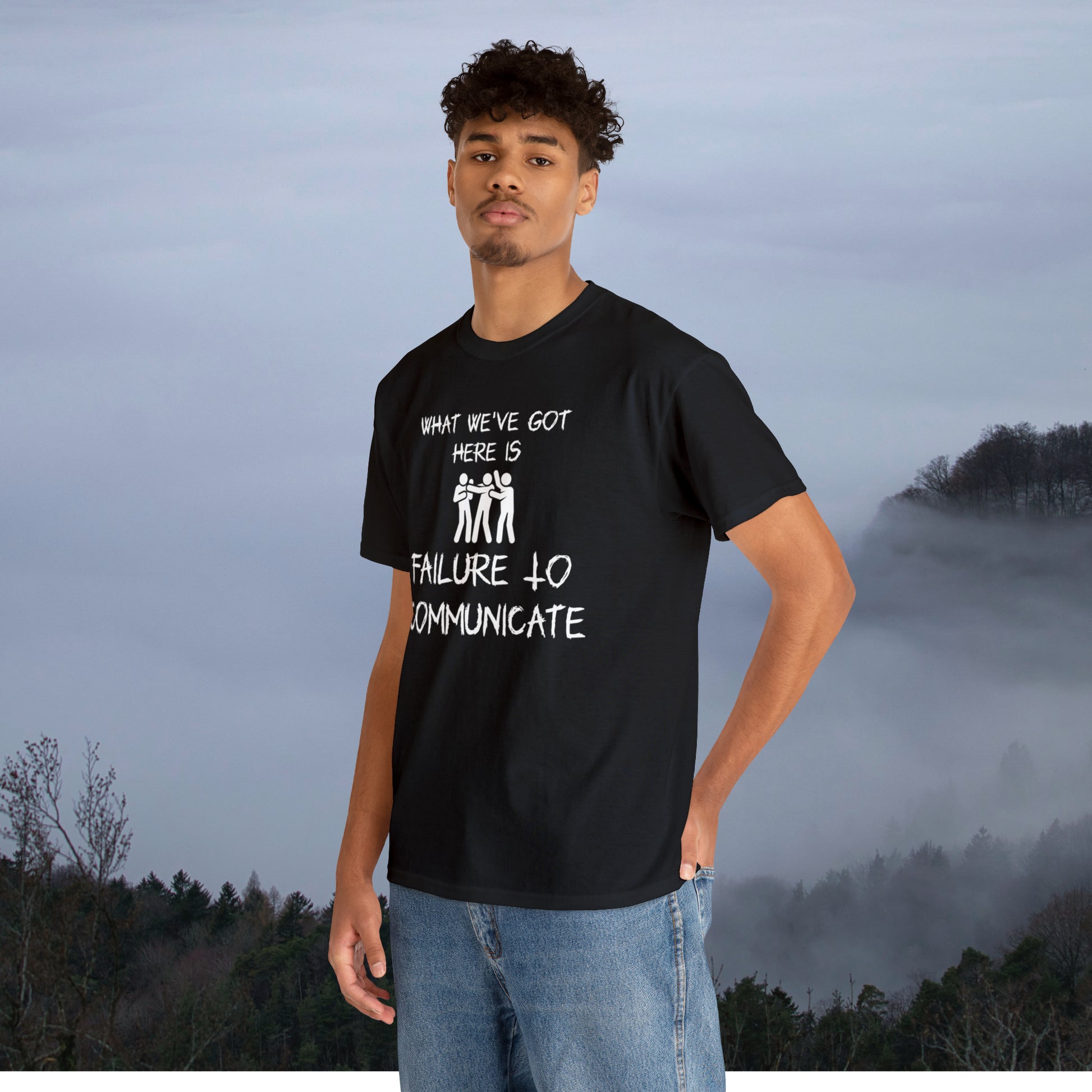 Young man in black graphic tee with smoky mountains in background