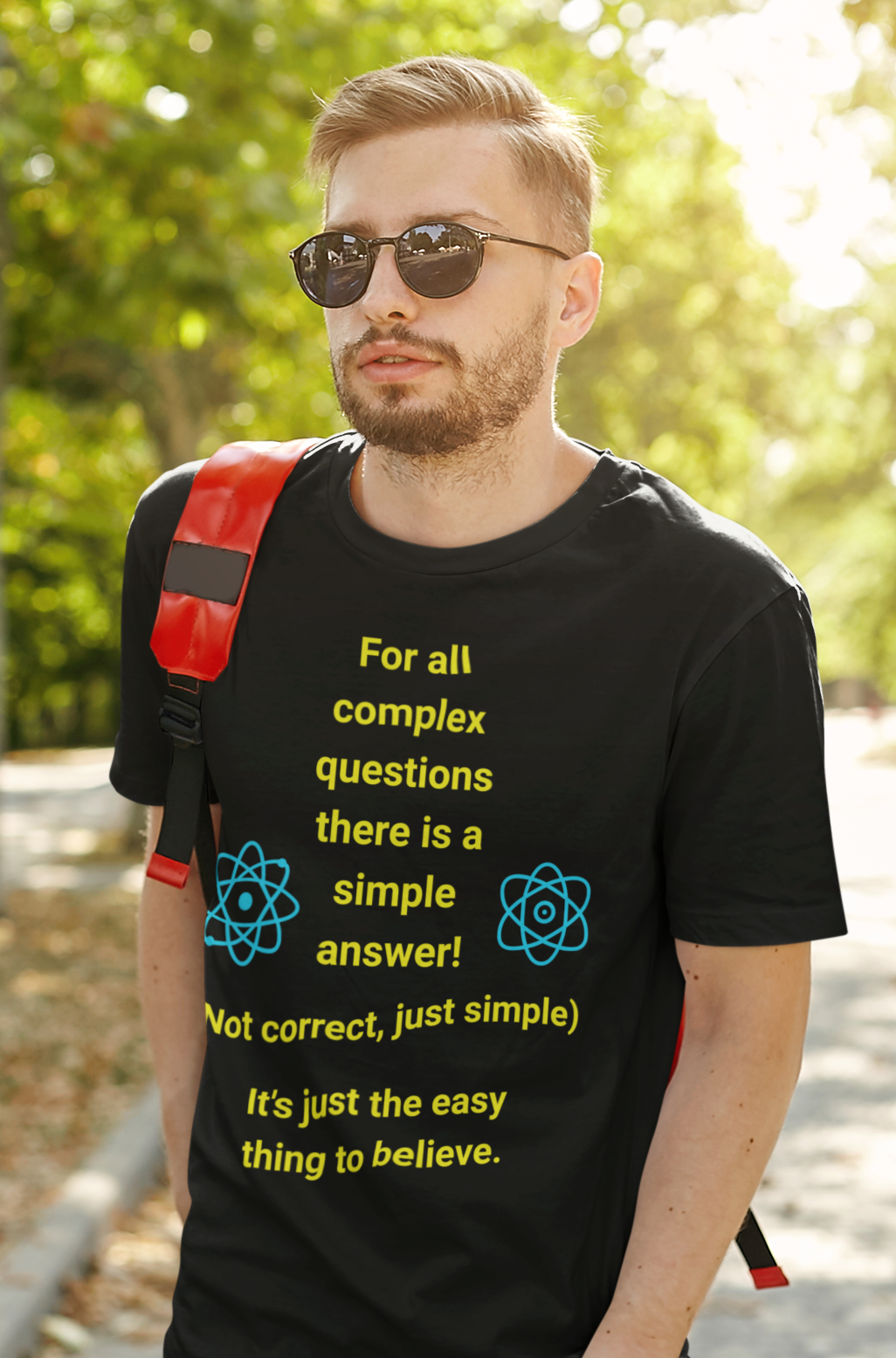 Young man in sunglasses wearing black tee with quote "Complex Questions"