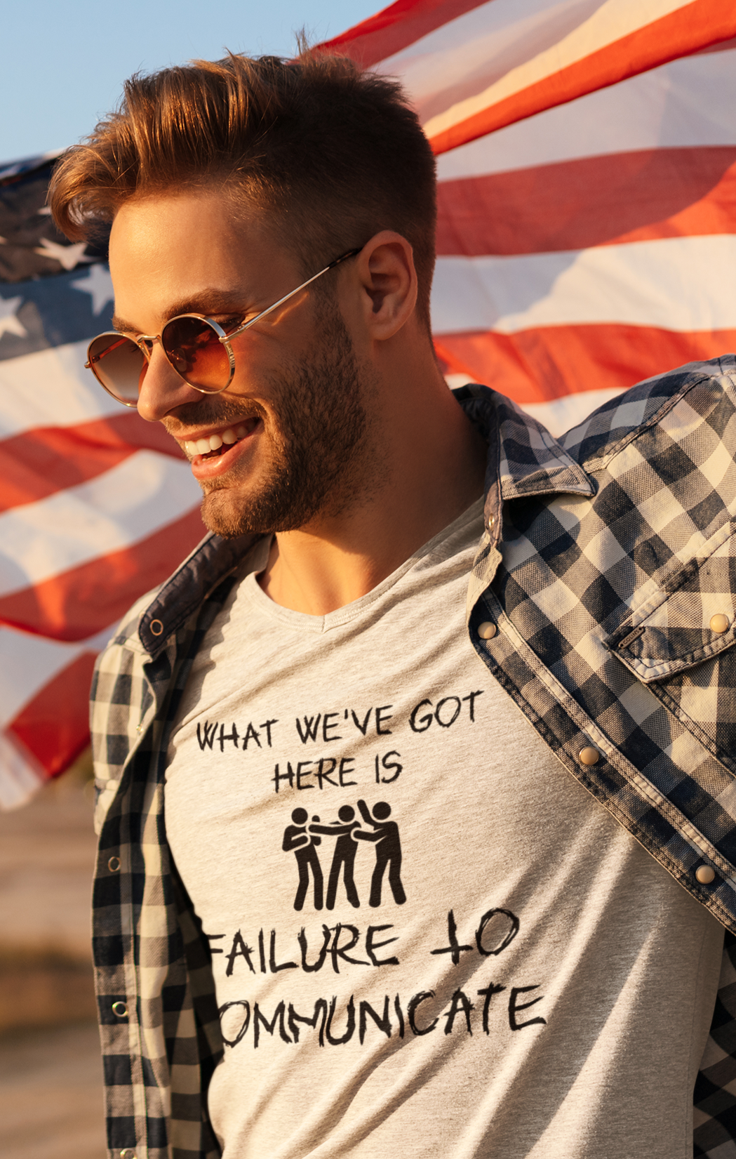 Stylish man with flag backdrop wearing tan shirt with graphic 