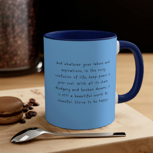 Navy Blue "Desiderata: Strive to be Happy" quote mug, on wood table with a spoon nearby.